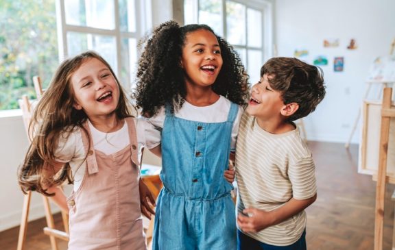 Portrait of three children during painting class